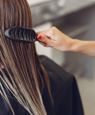 woman-drying-hair-in-a-hairsalon_1157-27184